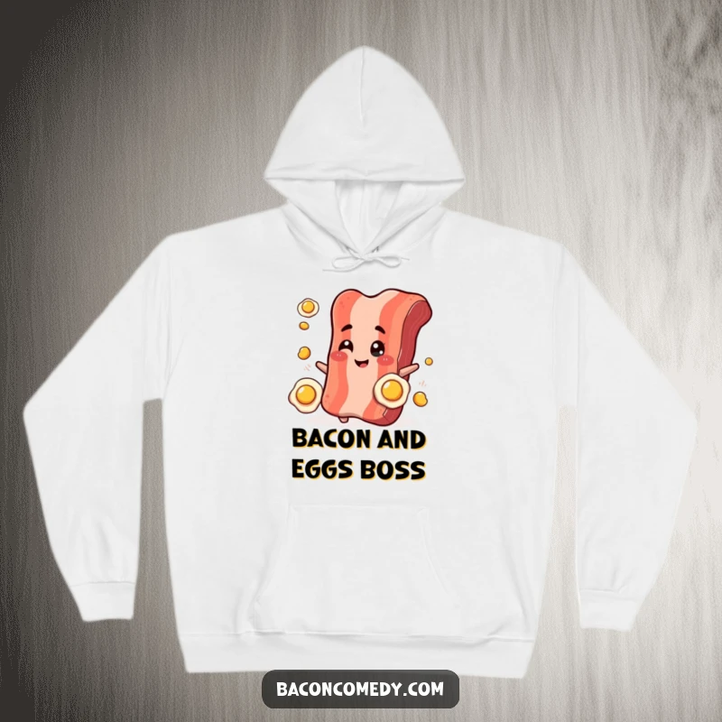 Funny Bacon Juggling Hoodie: A plump, smiling bacon strip winks while juggling tiny fried eggs, offering cozy breakfast fun.