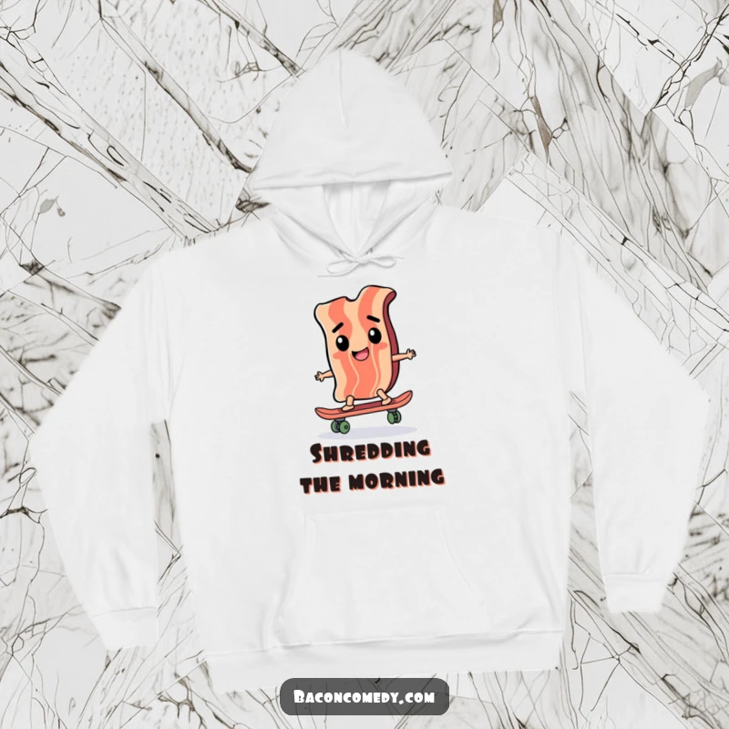 Funny hoodie featuring a happy bacon slice mastering a miniature skateboard with intense concentration, embodying skate culture and humor.